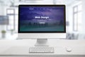 Responsive web site presentation on computer display. Office desk with keyboard and mouse Royalty Free Stock Photo