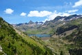 Respumoso dam Embalse de Respumoso among barren rocky mountains with snow and blue sky in a sunny summer in Panticosa, Aragon Royalty Free Stock Photo