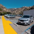 Rest area on California Highway in USA with a parking lot, cars, people and toilet