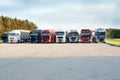 A row of multicolored trucks on a rest stop. Royalty Free Stock Photo