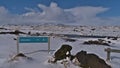 Rest area beside ring road with information sign, volcanic rocks and view on the ice cap of MÃÂ½rdalsjÃÂ¶kull glacier in winter. Royalty Free Stock Photo
