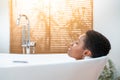 Rest, calm, pleasure, happiness and wellbeing concept. Attractive woman relaxing in foam bath. Royalty Free Stock Photo