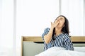 Rest, holidays, comfort and people concept, Portrait of sleepy asian woman in sleepwear yawning after her waking up so early