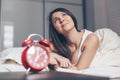 Rest, inspiration, creativity, comfort and people concept. Happy young woman dreaming in bed at home bedroom Royalty Free Stock Photo