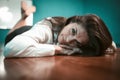 Rest in office concept. Sleepy business woman lying on office table. Tired or exhausted pretty female worker resting in Royalty Free Stock Photo