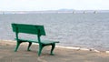 A rest park bench and a view from the shore of a low-water bridge from the Sedanka station to the De Friz peninsula across the Amu