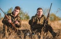 Rest for real men concept. Hunters with rifles relaxing in nature environment. Hunting with friends hobby leisure