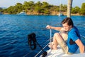 Rest on the sea, boat trip on a yacht. A young man in blue t-shirt.