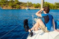 Rest on the sea, boat trip on a yacht. A young man in blue t-shirt.