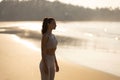 Rest of sportswoman runner after workout on sandy beach