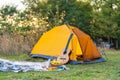 Rest with a tent in the woods by the river. The pleasure of nature. Camping with a tent. Fresh air Royalty Free Stock Photo