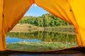 Rest with a tent in the woods by the river. The pleasure of nature. Camping with a tent. Fresh air Royalty Free Stock Photo