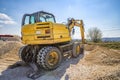 Rest, yellow excavator with shovel at construction site. Royalty Free Stock Photo