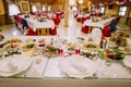 Restaurant banquet table served for celebration. Close-up on different food, glasses and plates