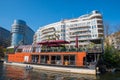 Restaurant on a barge on Spree river with apartment building in the background