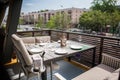 A restaurant with beautifully furnished interiors, comfortable armchairs and served tables on a spacious outdoor terrace