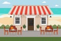 a restaurant cafe on the beach by the sea with a table and chairs Royalty Free Stock Photo