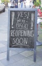 Restaurant or cafe display announcing reopening business after the corona lockdown, with the message yes we`re back, outdoo