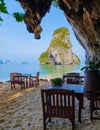 restaurant with chairs on the beach at a limestone cliff grotto at Railai Beach Krabi Thailand Royalty Free Stock Photo