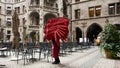 Empty Restaurant with one waiter collecting red seat cushions, at the Rathaus in Munich Germany