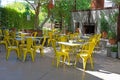 Restaurant courtyard with yellow chairs under the trees
