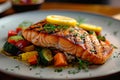 Restaurant dish grilled salmon presented with colorful veggies and lemon