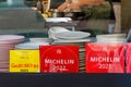 Restaurant display window with Michelin and Gault & Millau award placards in Arnhem, The Netherlands