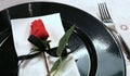 Elegantly prepared table with a red rose on the black plate Royalty Free Stock Photo