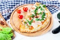 Close up view on Calzone on a pizza board on white background with herbs and spices. Royalty Free Stock Photo