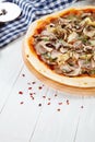 Close up view on pizza on white wooden background with ingridients. Royalty Free Stock Photo