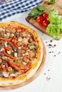Close up view on pizza on white wooden background with ingridients. Royalty Free Stock Photo