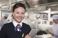 Restaurant Hostess in an Industrial Kitchen Royalty Free Stock Photo