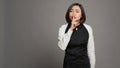 Restaurant hostess showing silence symbol in studio