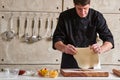 Restaurant hotel private chef preparing pizza rolling flattening