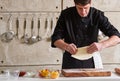 Restaurant hotel private chef preparing pizza rolling flattening