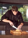 Restaurant hotel private chef slicing fresh loaf of bread