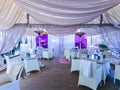 Restaurant interior with soft textile ceiling and white wicker furniture overlooking the Baltic coast Royalty Free Stock Photo