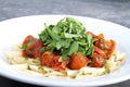 Penne pasta, roasted cherry tomatoes, rocket and pesto. Royalty Free Stock Photo