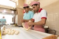 Restaurant male workers carving the dough, table and hands in flour Royalty Free Stock Photo