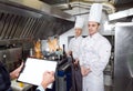 Restaurant manager briefing to his kitchen staff in the commercial kitchen Royalty Free Stock Photo