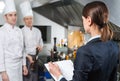 Restaurant manager briefing to his kitchen staff in the commercial kitchen. Royalty Free Stock Photo