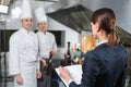 Restaurant manager briefing to his kitchen staff in the commercial kitchen. Royalty Free Stock Photo