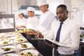 Restaurant manager with his kitchen staff Royalty Free Stock Photo