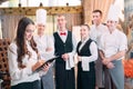 Restaurant manager and his staff in kitchen. interacting to head chef in commercial kitchen. Royalty Free Stock Photo