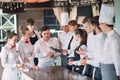 Restaurant manager and his staff in terrace. interacting to head chef in restaurant.