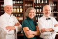 Restaurant manager posing with professional staff