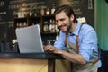 Restaurant manager working on laptop, counting profit Royalty Free Stock Photo