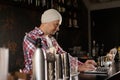 Restaurant manager working on laptop, counting profit. Royalty Free Stock Photo