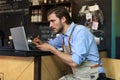 Restaurant manager working on laptop, counting profit Royalty Free Stock Photo