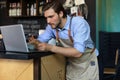 Restaurant manager working on laptop, counting profit Royalty Free Stock Photo